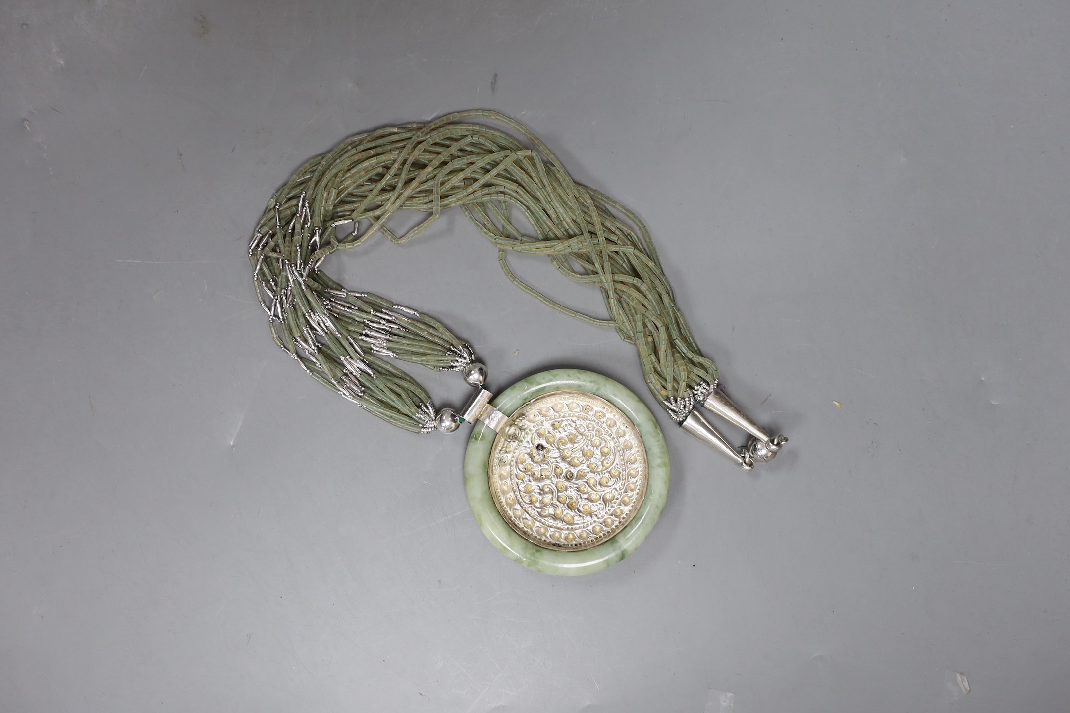 A Kai-Yin-Lo of Hong Kong jadeite and white metal mounted necklace, 81cm.